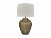 MAdney table lamp with textured bronze base and white lampshade on a white background