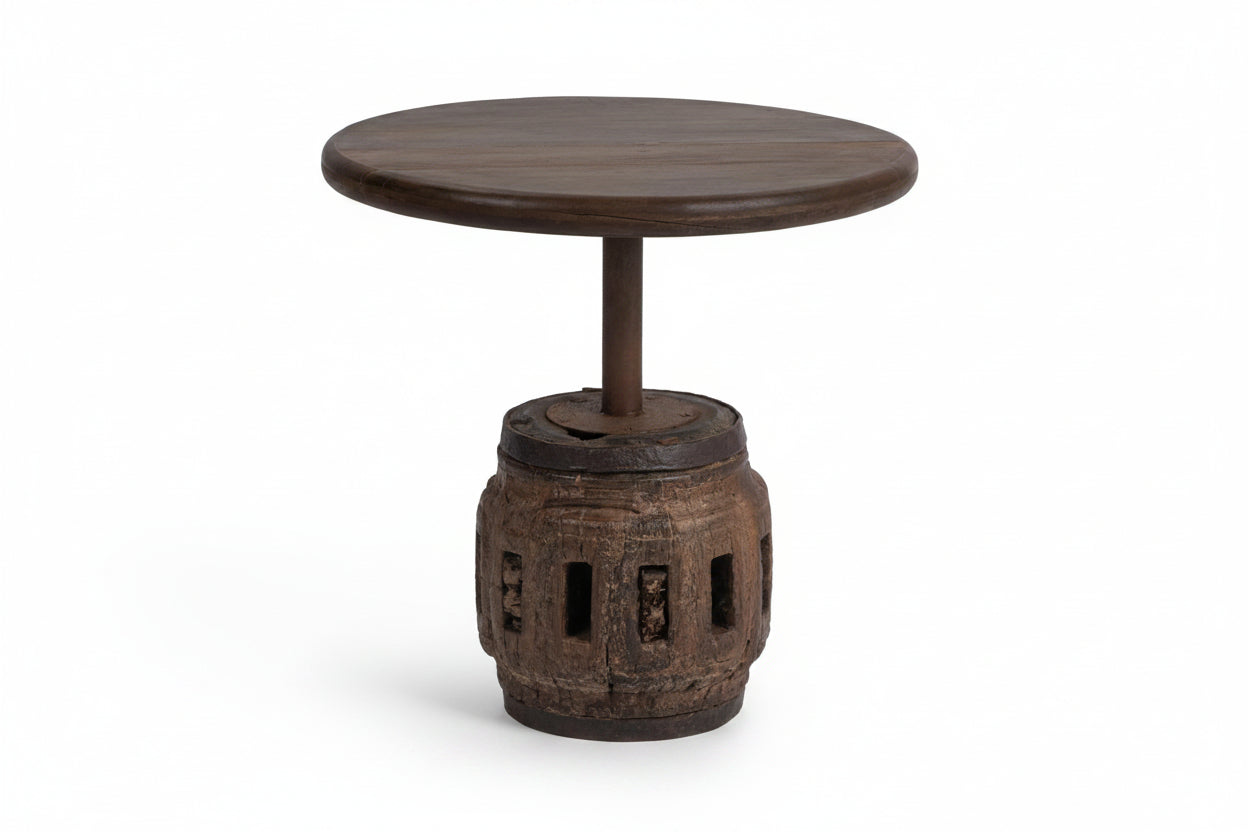 Wooden side table with round top and decorative base on a white background