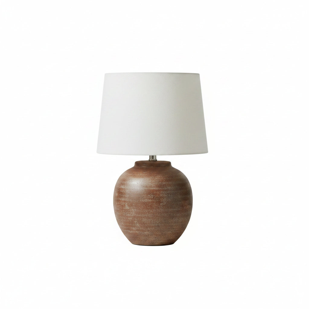 Decorative lamp on a wooden console table with a staircase in the background