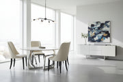Tangle dining table with marble top and modern chairs in a room scene.