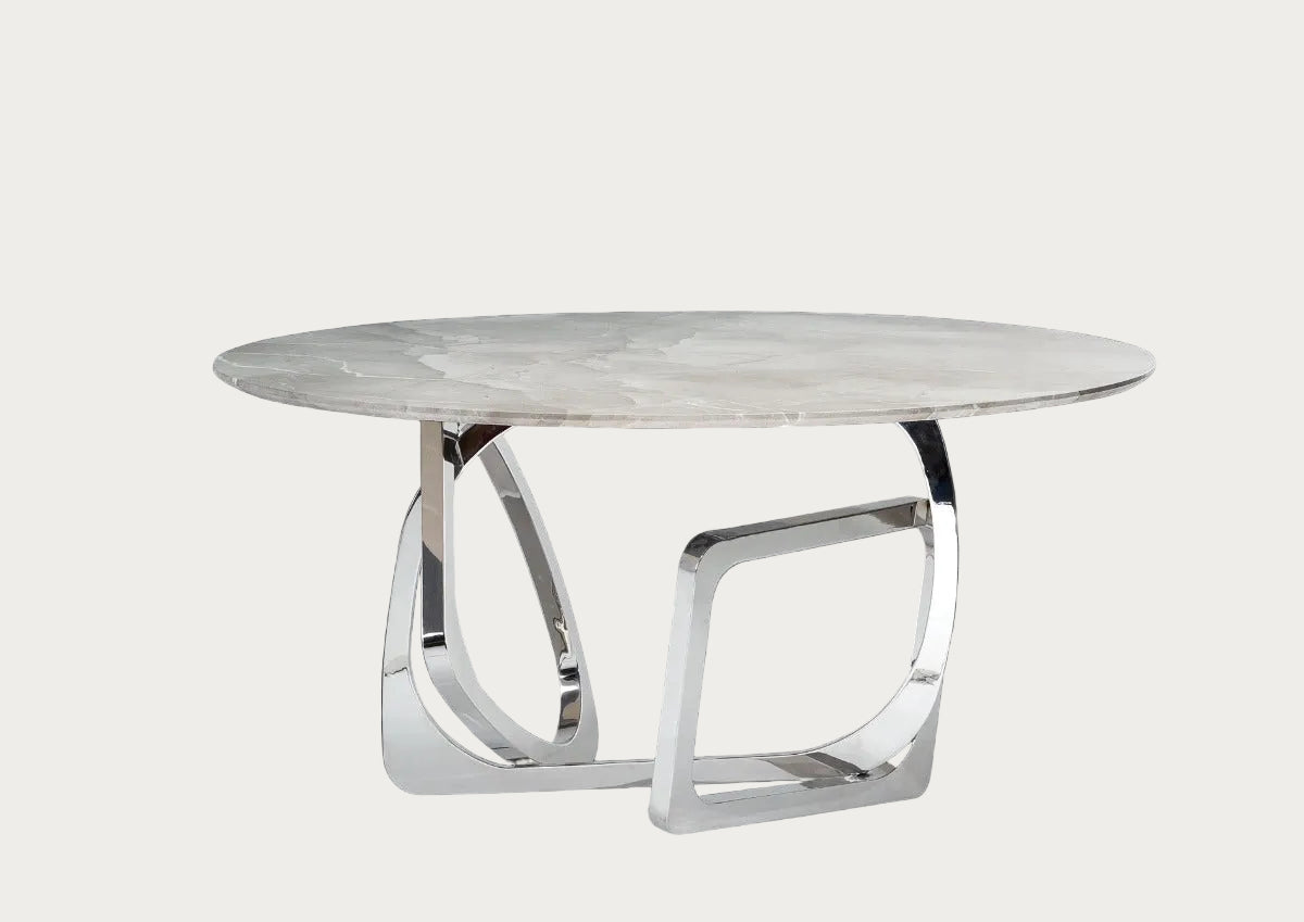 Modern round dining table with marble top and chrome base on a dark background