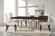 Tangle dining table with a unique base design and white chairs on a dark background.
