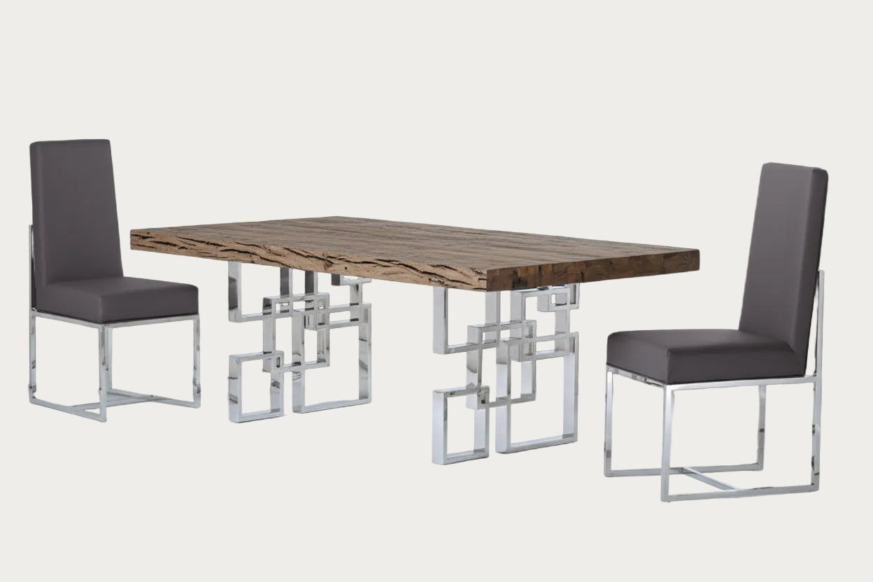 Dining table with modern metal legs and two gray chairs on a dark background