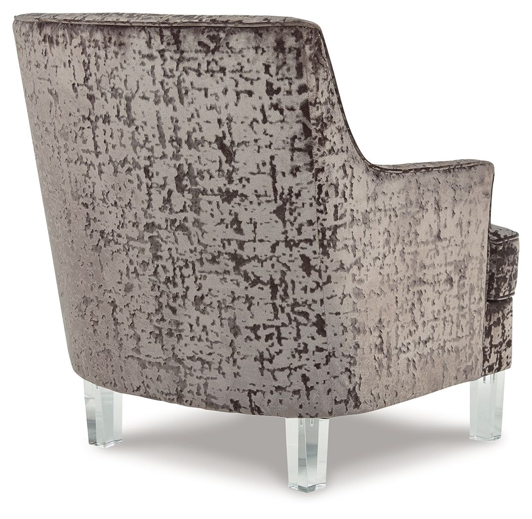 Patterned armchair with clear legs on a white background