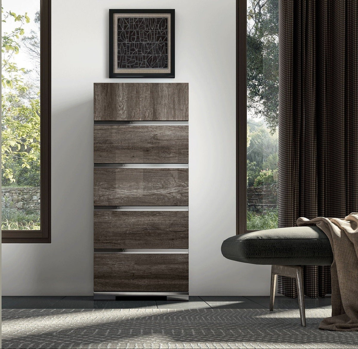 A tall, narrow wooden chest of drawers with a weathered brown wood-grain finish, styled in a modern room next to a dark green bench and large windows.