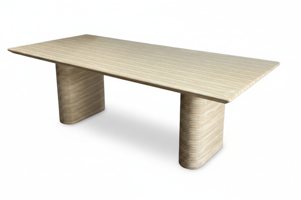 Beige textured table with unique cylindrical legs on a white background