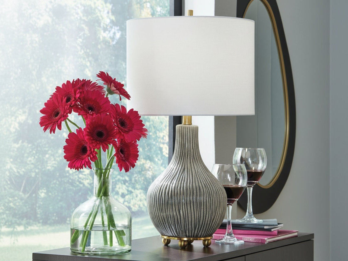 Judlen decorative lamp with a vase of red flowers and wine glasses on a table.