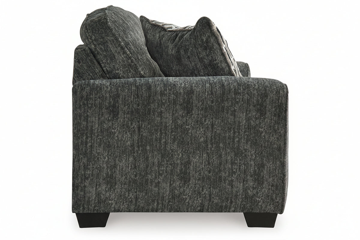 Gray textured sofa with decorative pillows on a white background