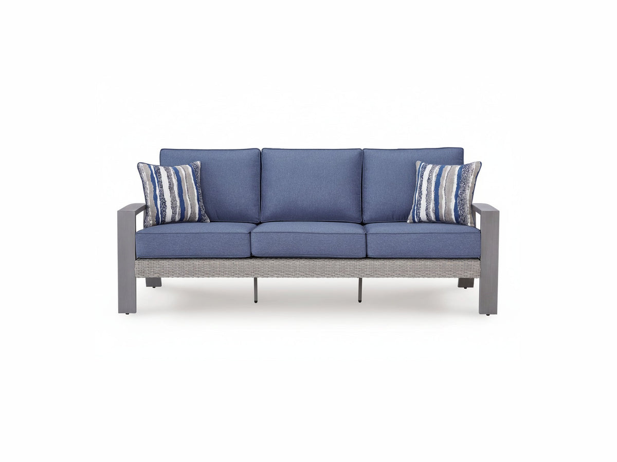 Blue outdoor sofa with striped cushions on a white background