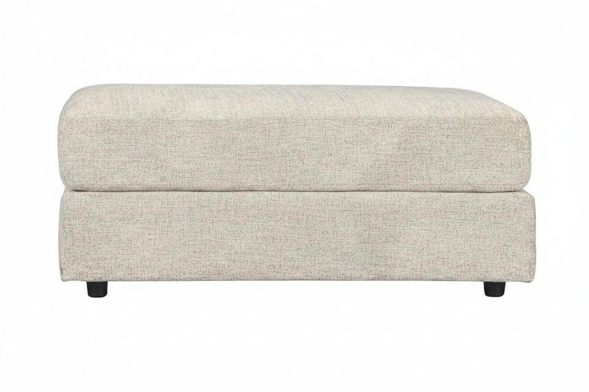 Beige ottoman with a textured surface on a white background