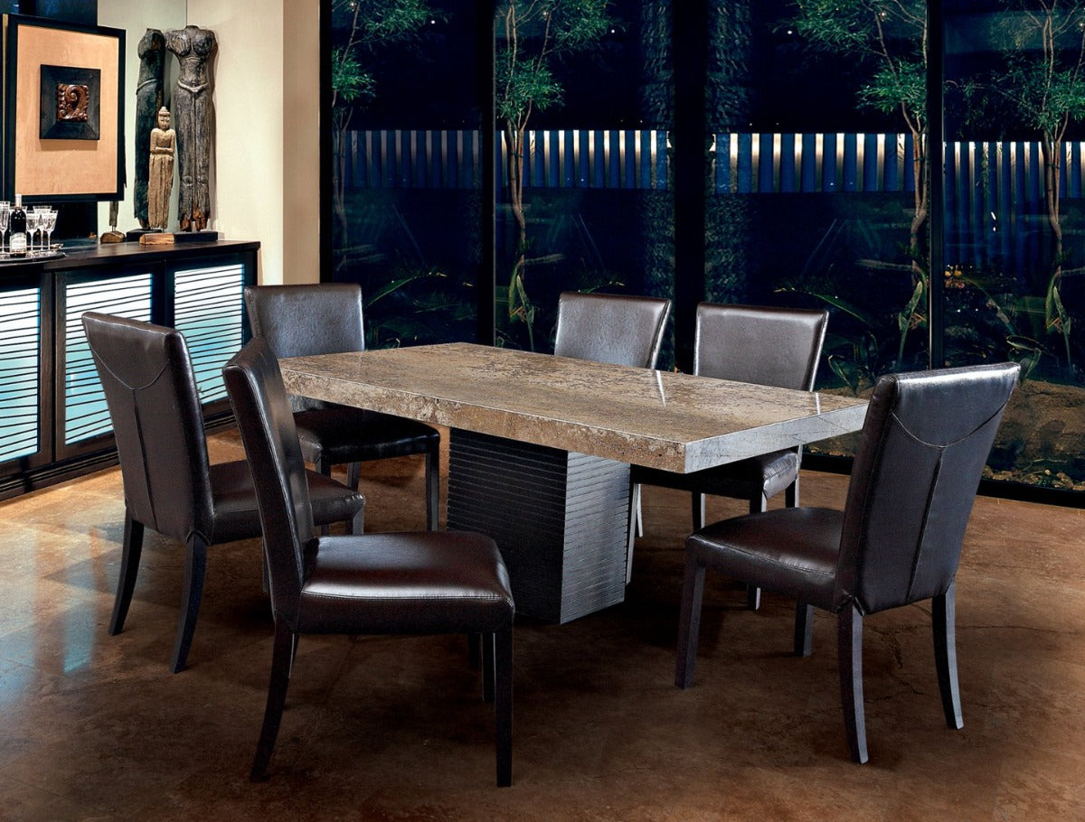 Dining room with a stone table and leather chairs in a modern interior setting.