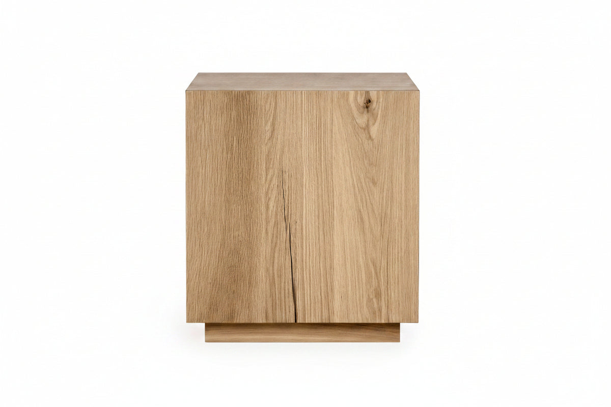 A modern square side table or cabinet made of light oak wood with a visible grain and a small central crack, shown on a plain white background.