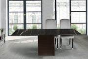 Modern dining table with marble-like surface in a stylish room with large windows.