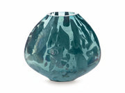 Teal glass vase with abstract patterns on a white background