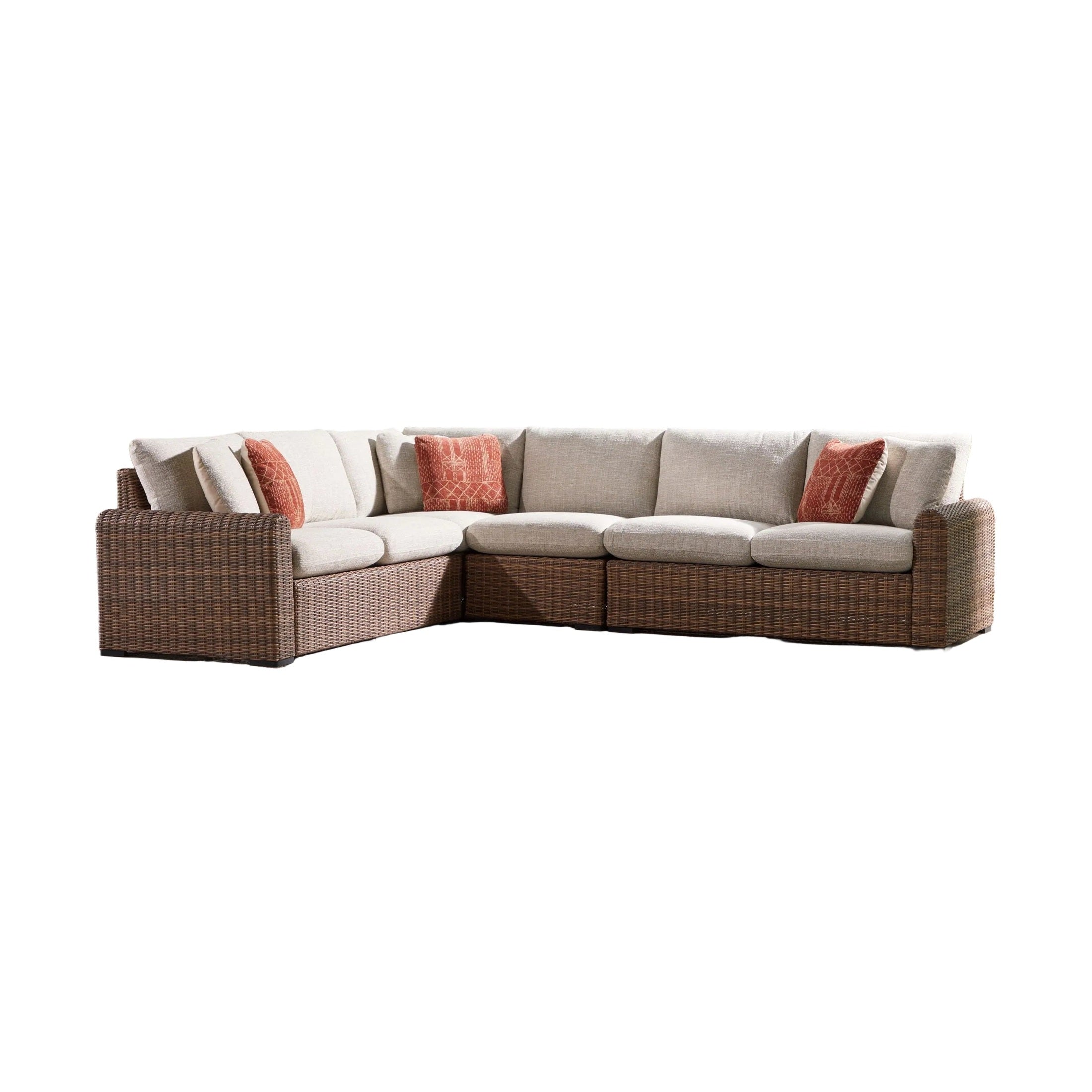 Outdoor sectional sofa with cushions on a patio with trees in the background