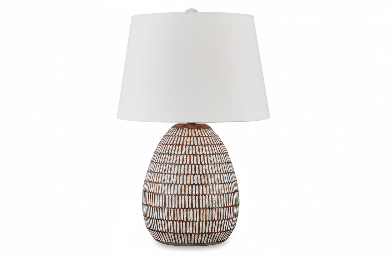 Darrich table lamp with textured ceramic base and white shade on a white background