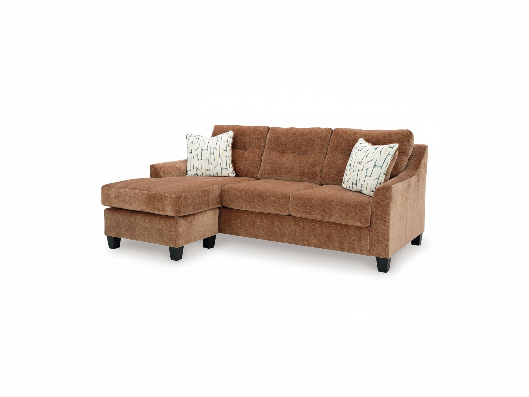 Brown sectional sofa with patterned cushions on a white background