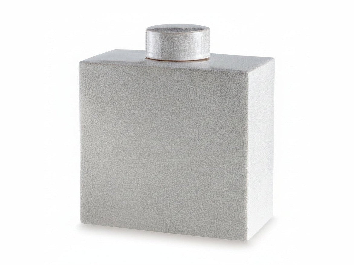 Silver textured square container with a cylindrical lid on a white background