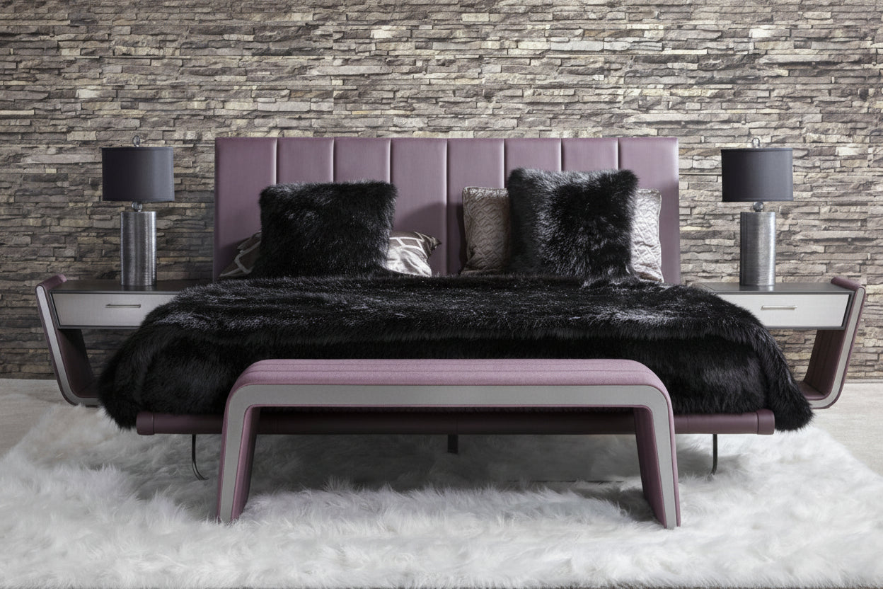 Zina modern bedroom set with a purple bed and a black fur throw against a stone wall.