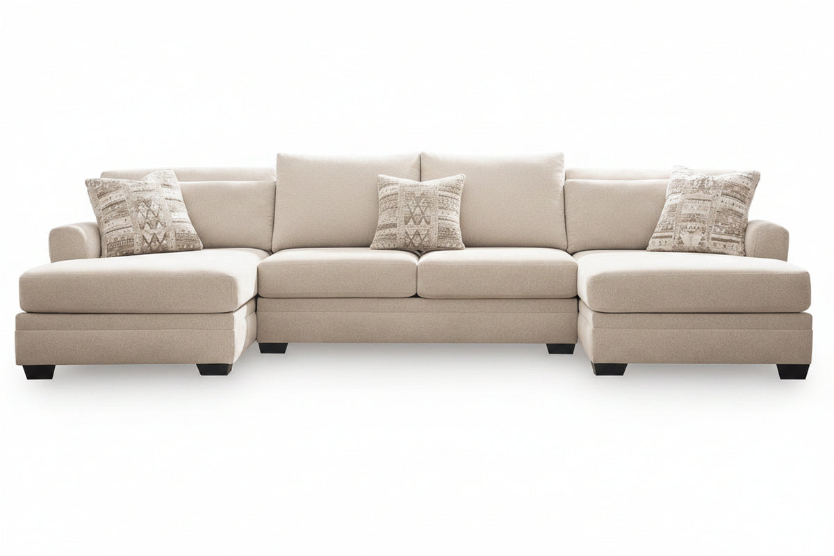 A light beige fabric sectional sofa with a left-facing chaise lounge, four matching throw pillows, and two patterned accent pillows, shown against a plain white background.