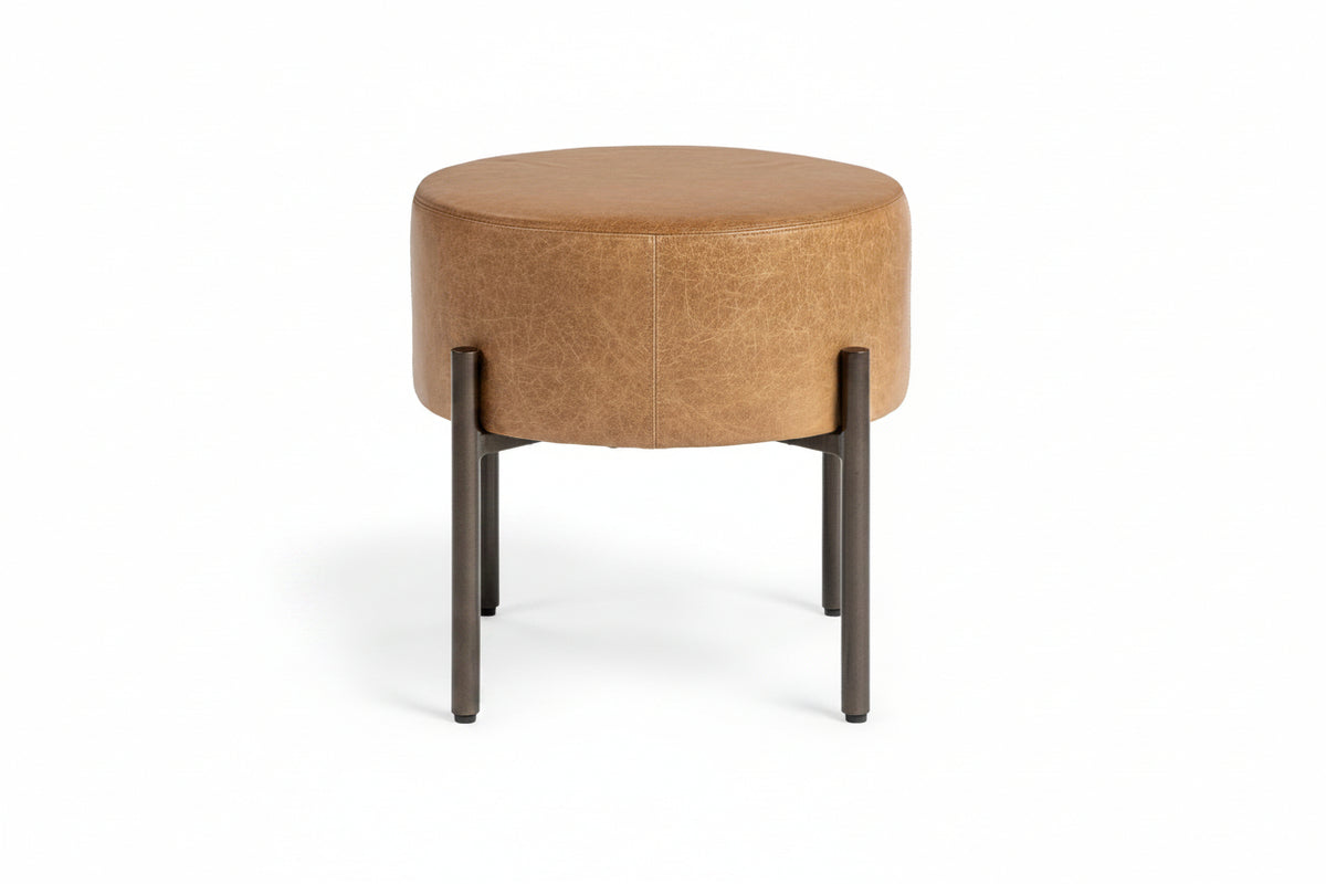 Round brown ottoman with black legs on a white background