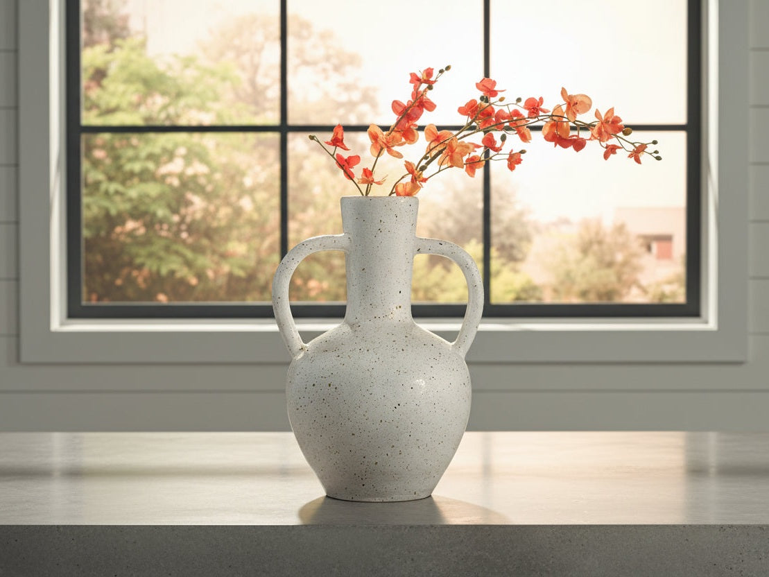 Dallinworth white speckled vase with floral arrangement on a wooden surface