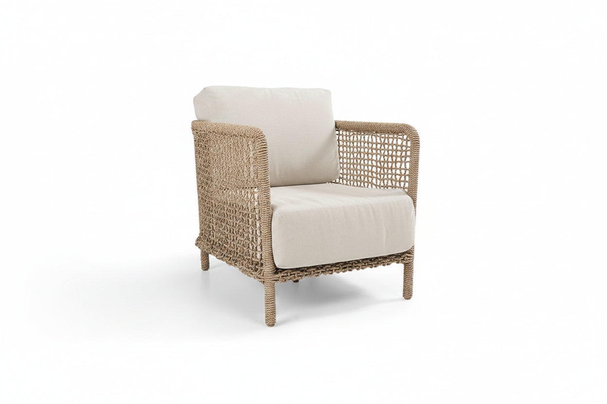 Wicker armchair with beige cushions on a white background