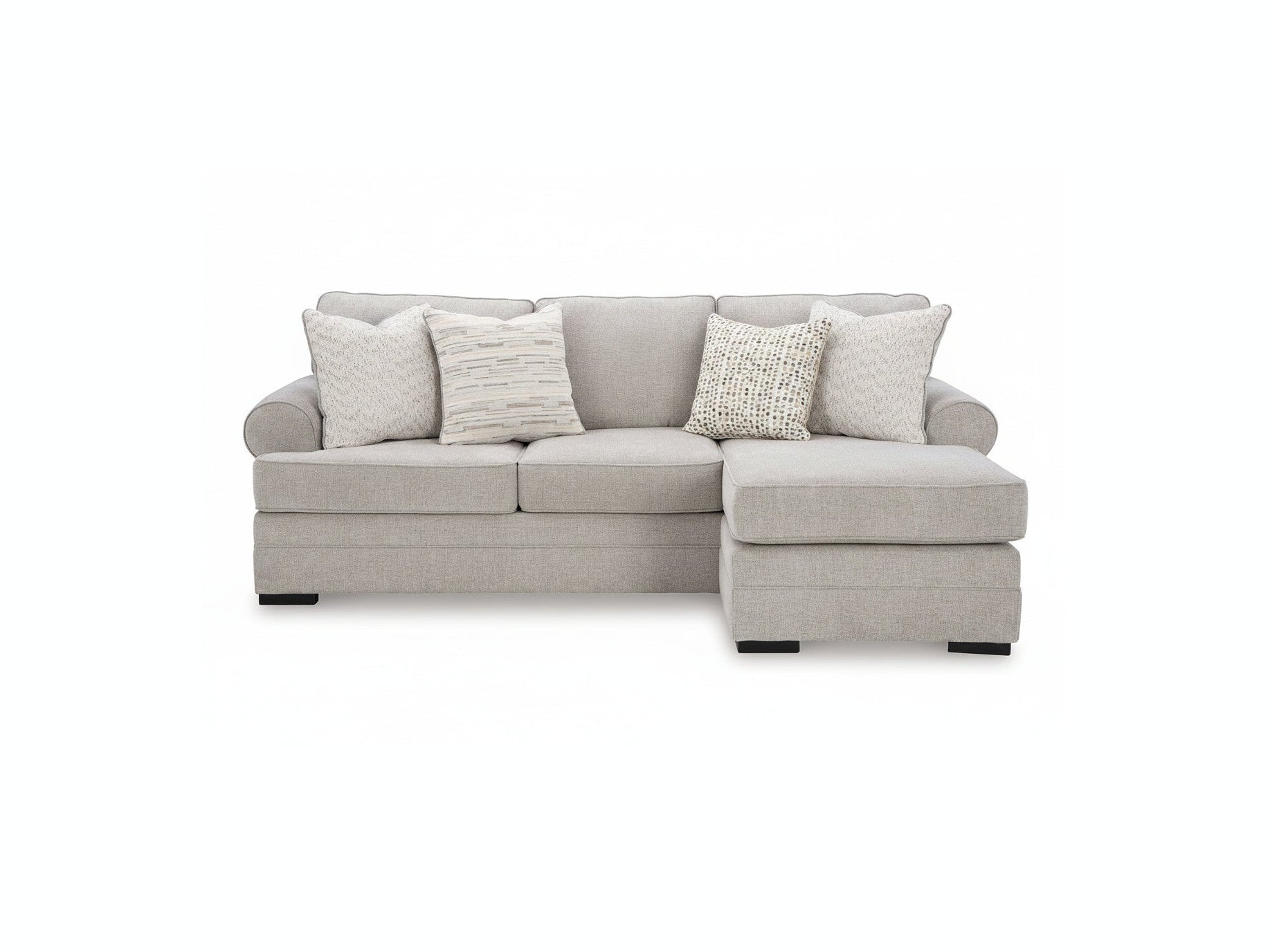 Gray sectional sofa with patterned cushions on a white background