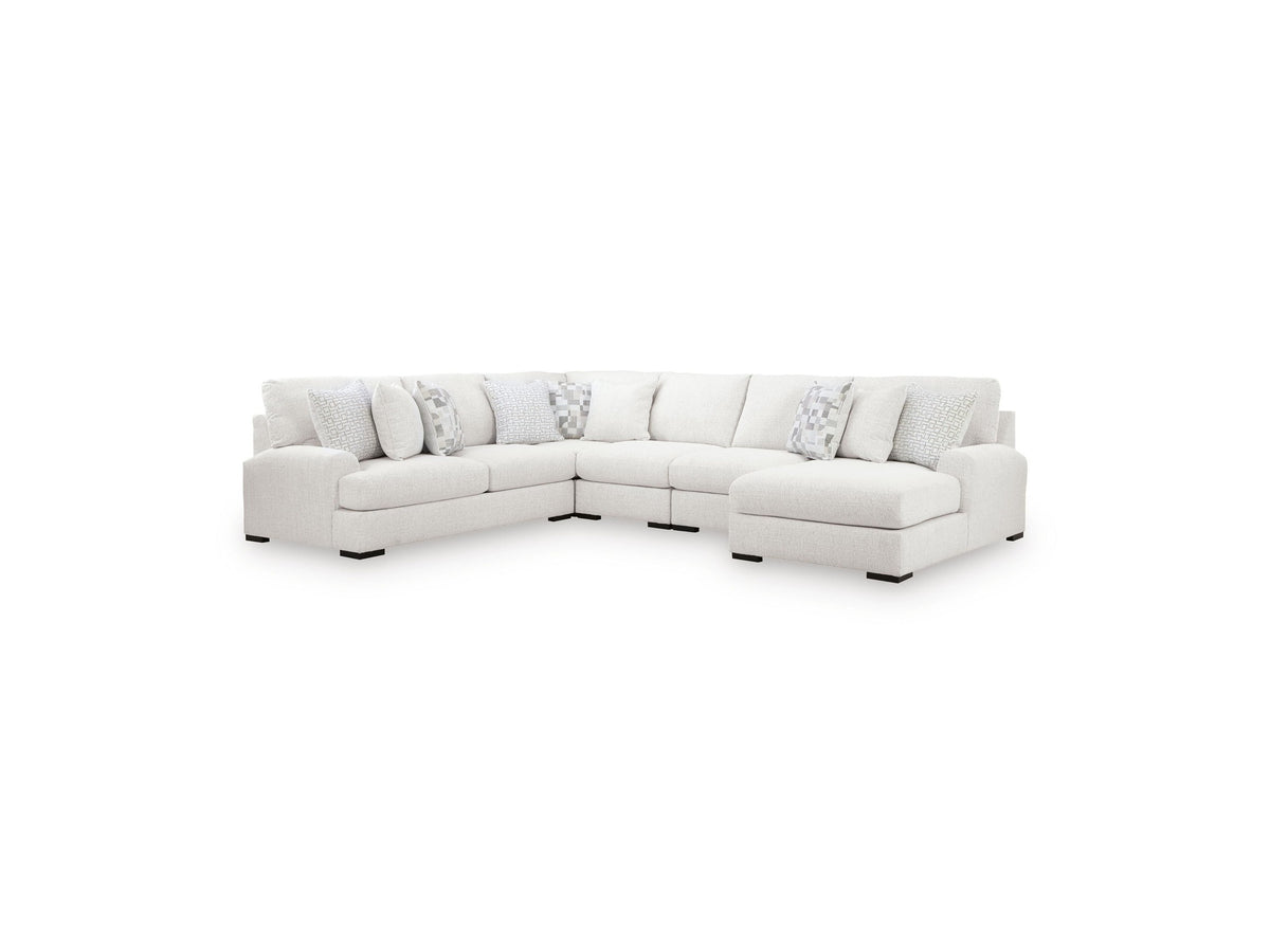 White sectional sofa with patterned cushions on a white background