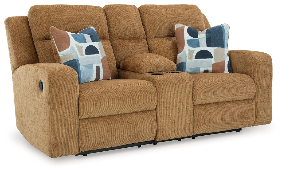 Brown sofa with two patterned cushions on a white background