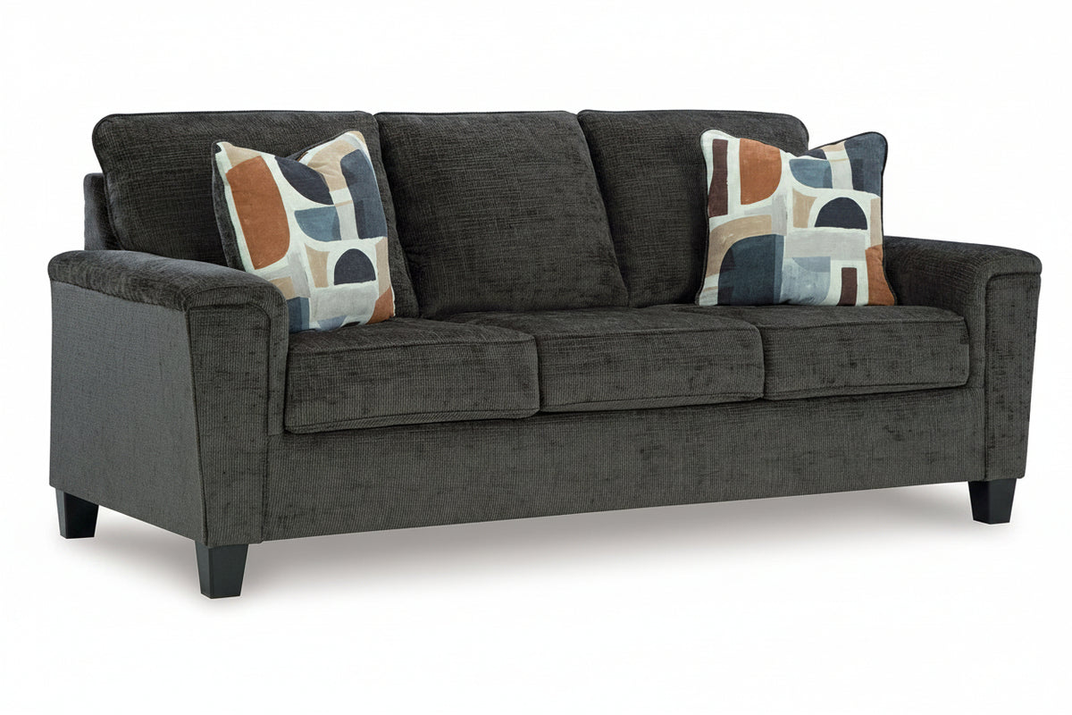 Gray sofa with patterned cushions on a white background