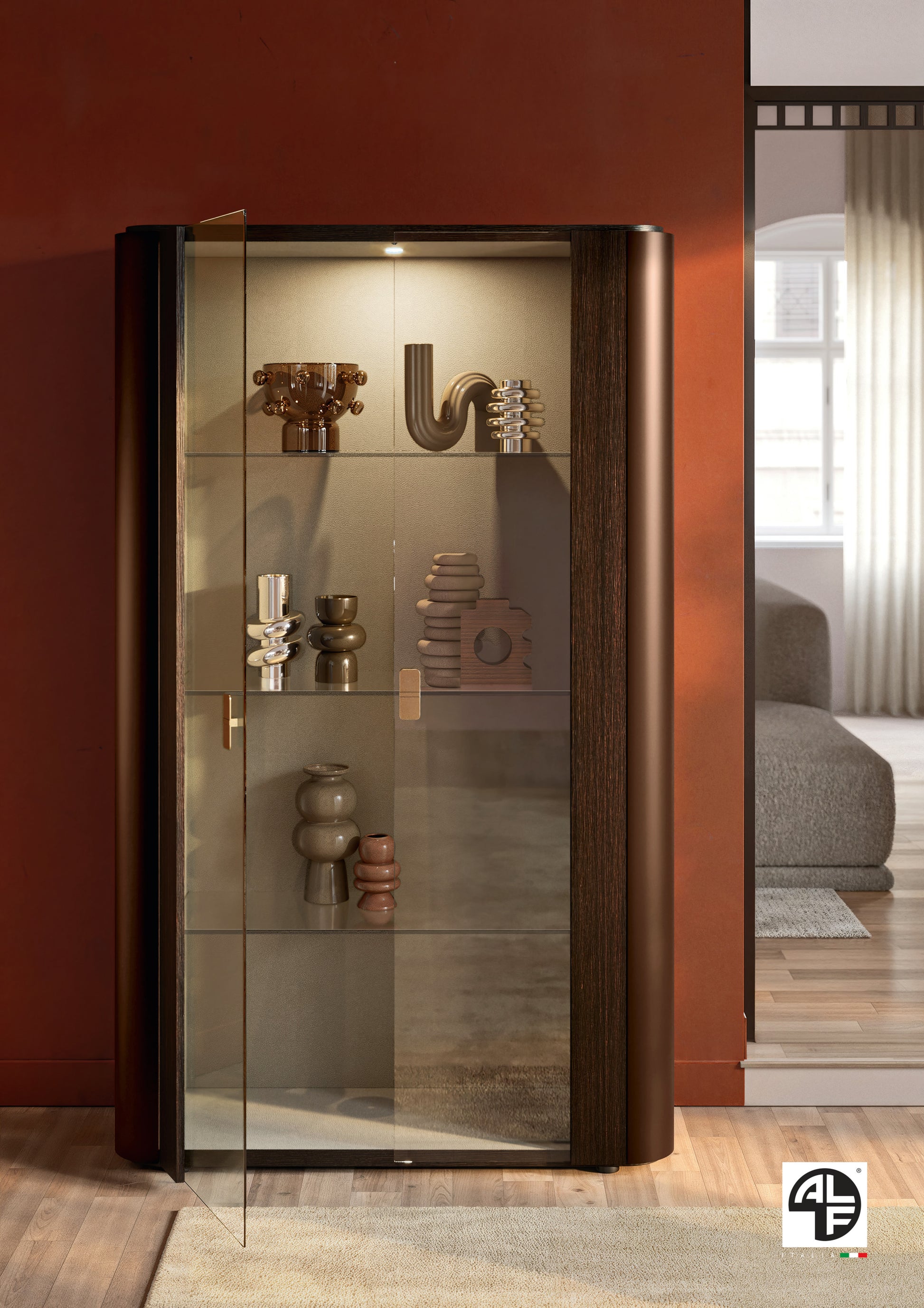 Appia modern glass display cabinet with decorative items against a red wall.