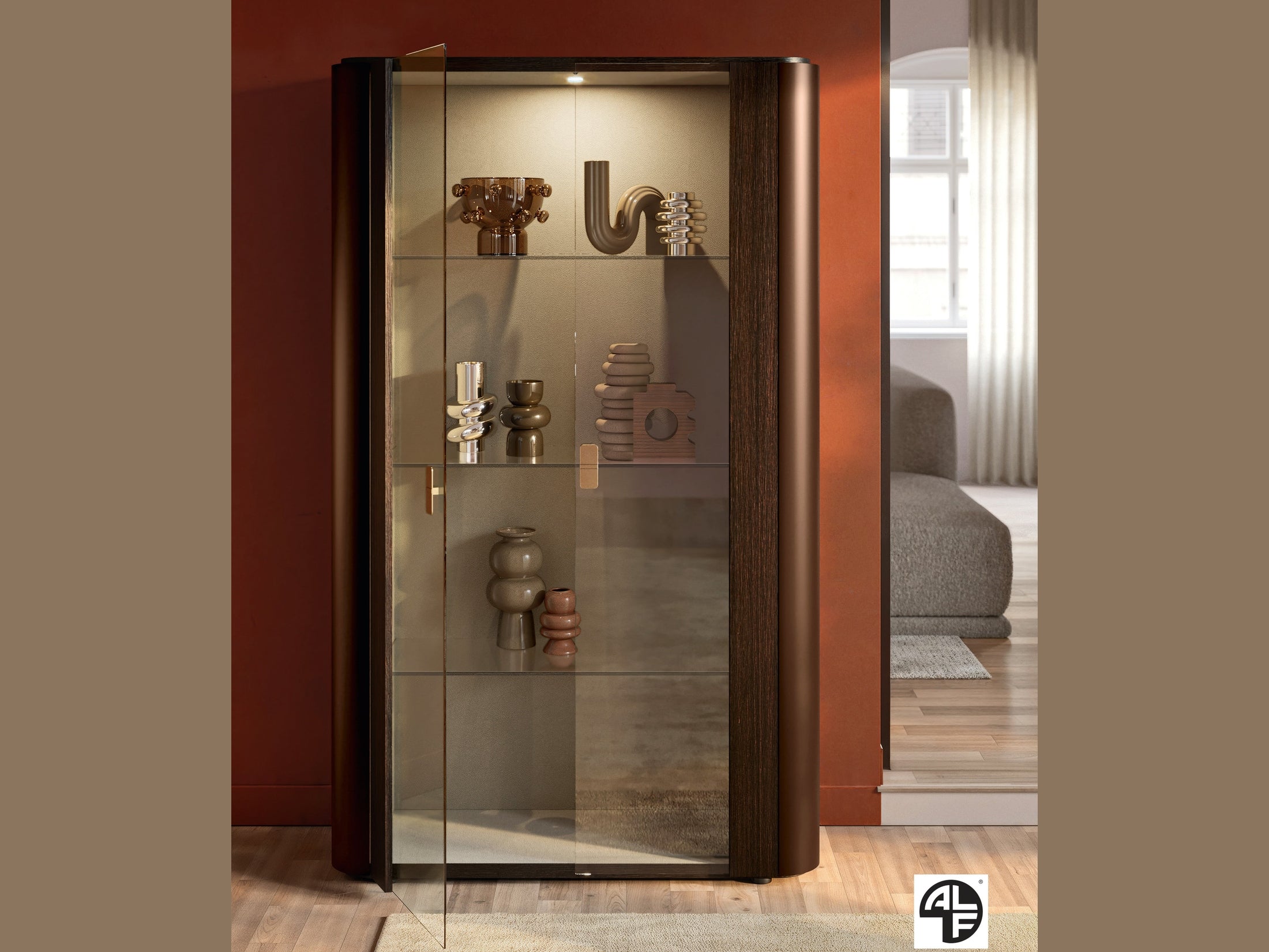 Appia modern glass display cabinet with decorative items against a red wall.