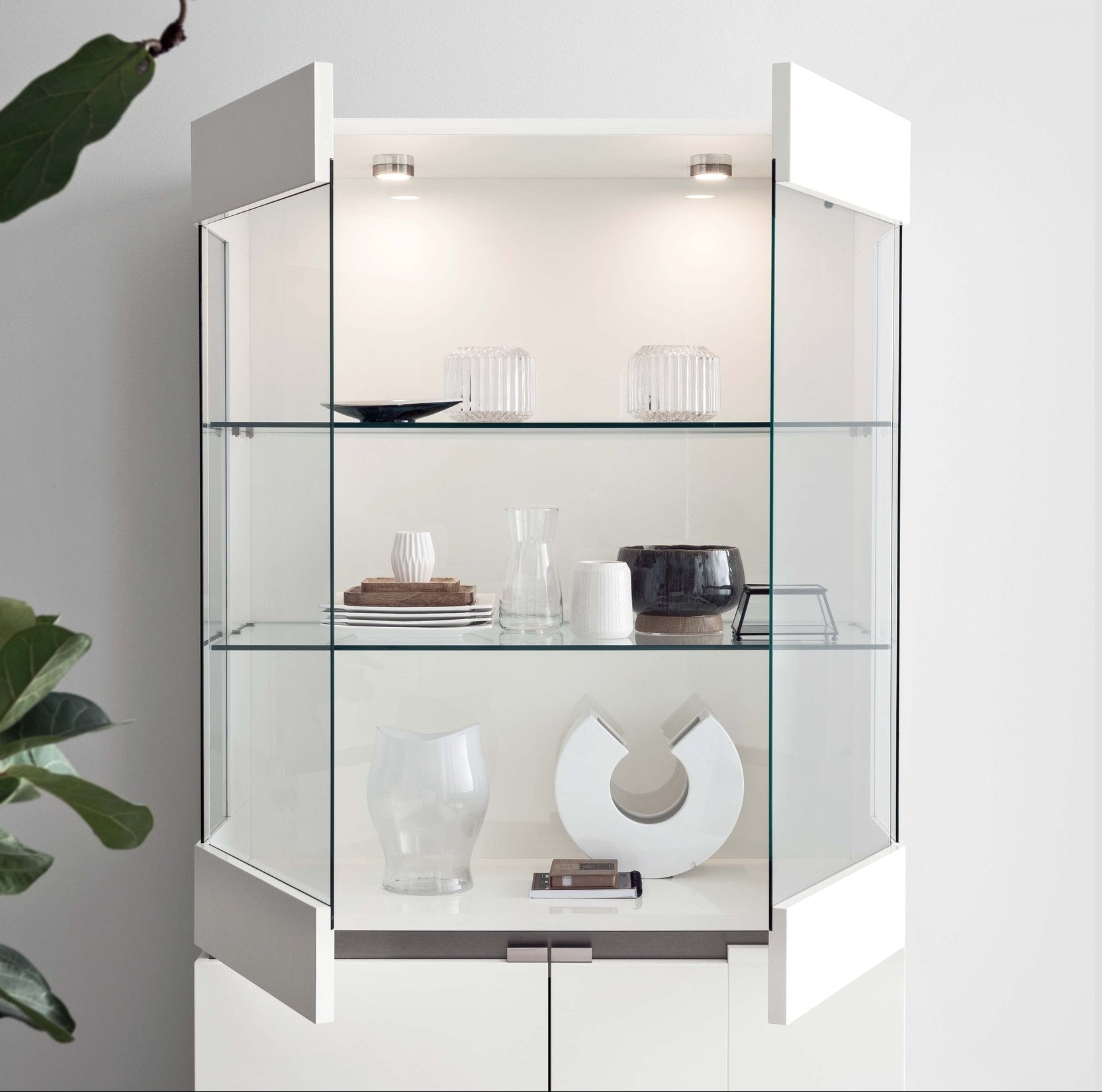 Artemide glass display cabinet with interior lighting on a white background