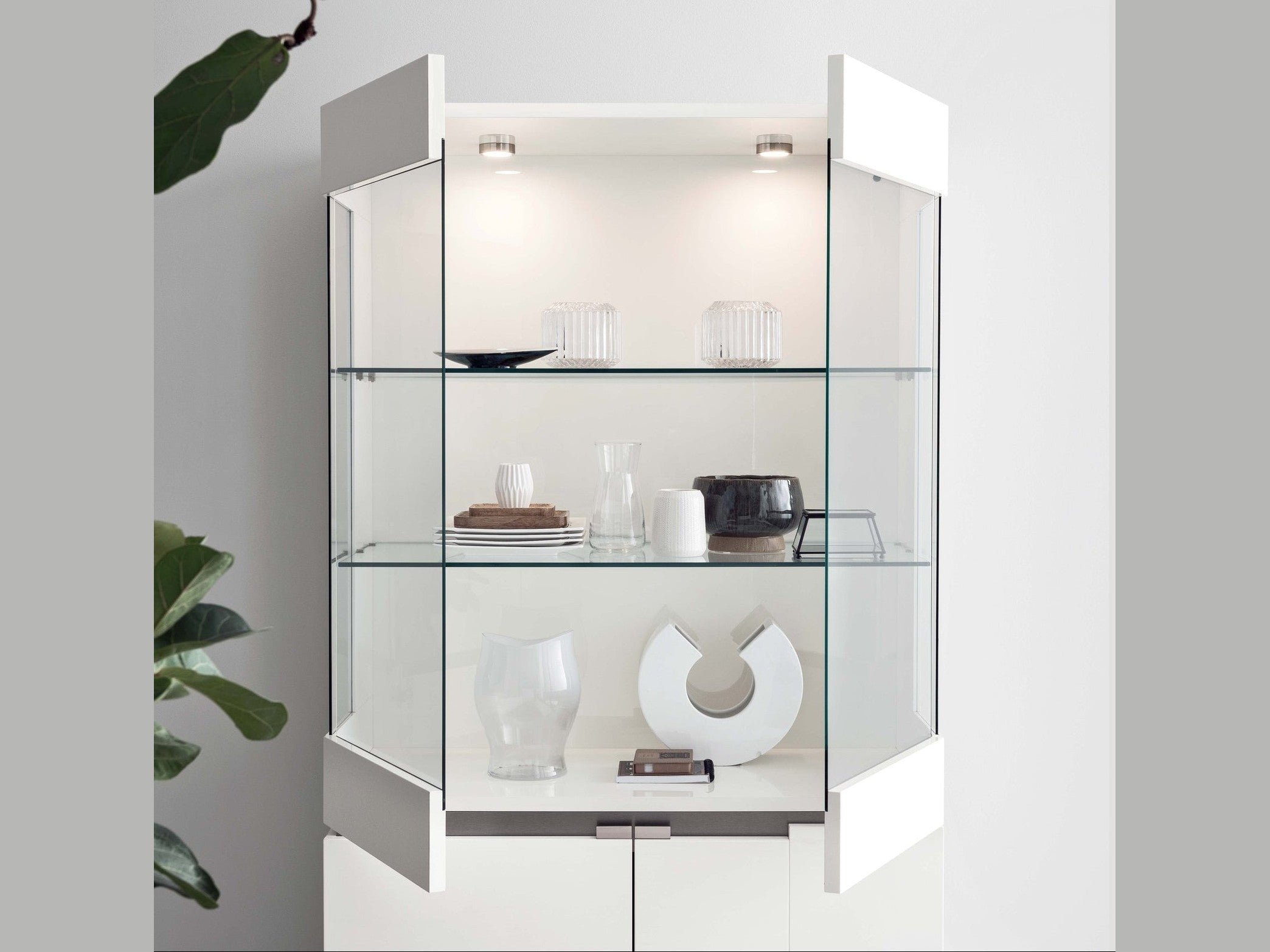 Artemide glass display cabinet with interior lighting on a white background