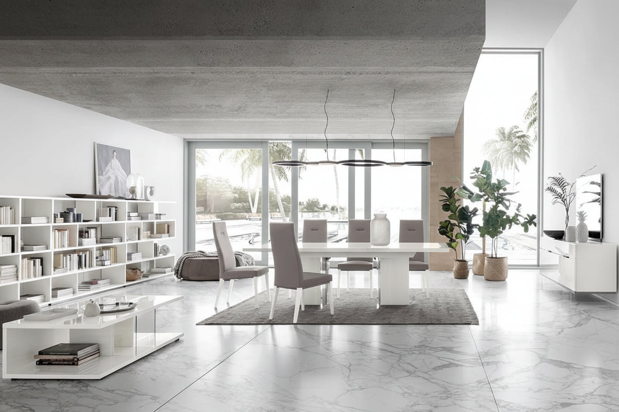 Artemide modern living room with a dining area featuring a white table and gray chairs.