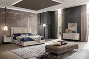 The Claire modern bedroom set with gray walls, a white bed, and a gray rug.