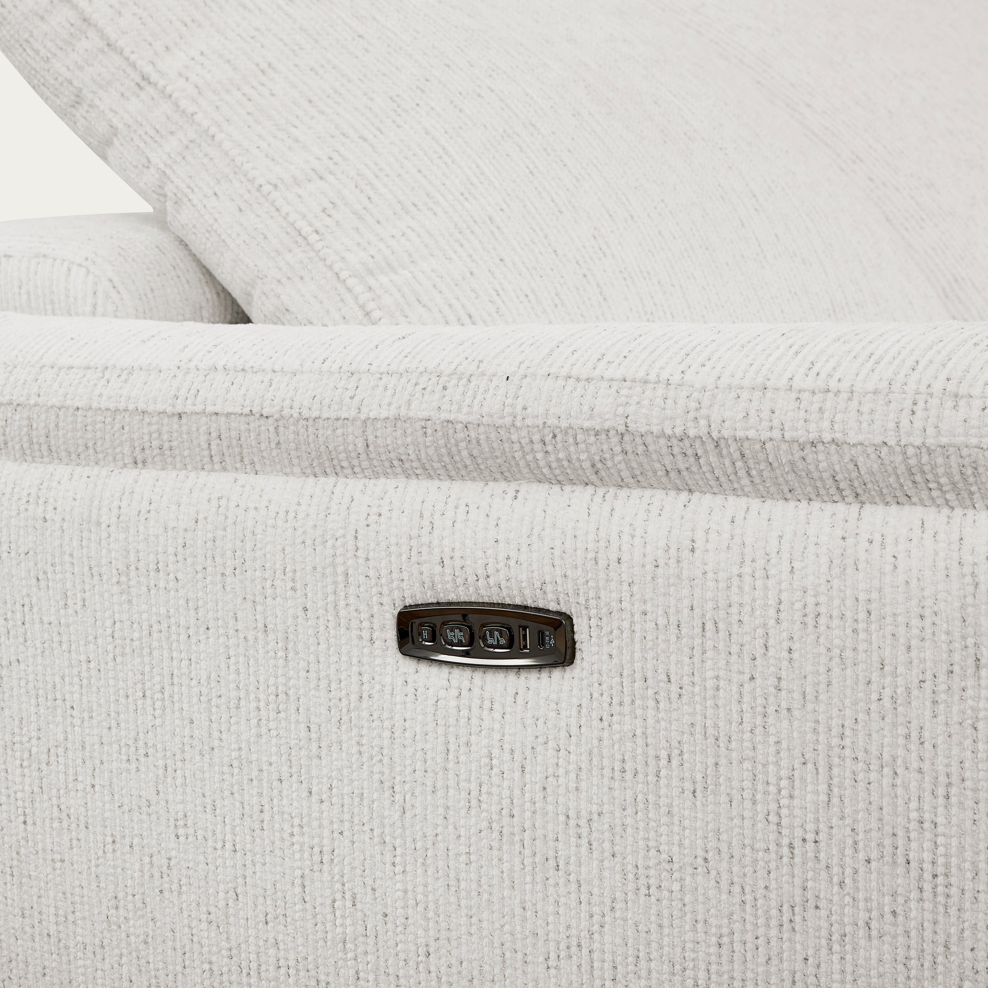 Close-up of a textured white fabric reclining sofa