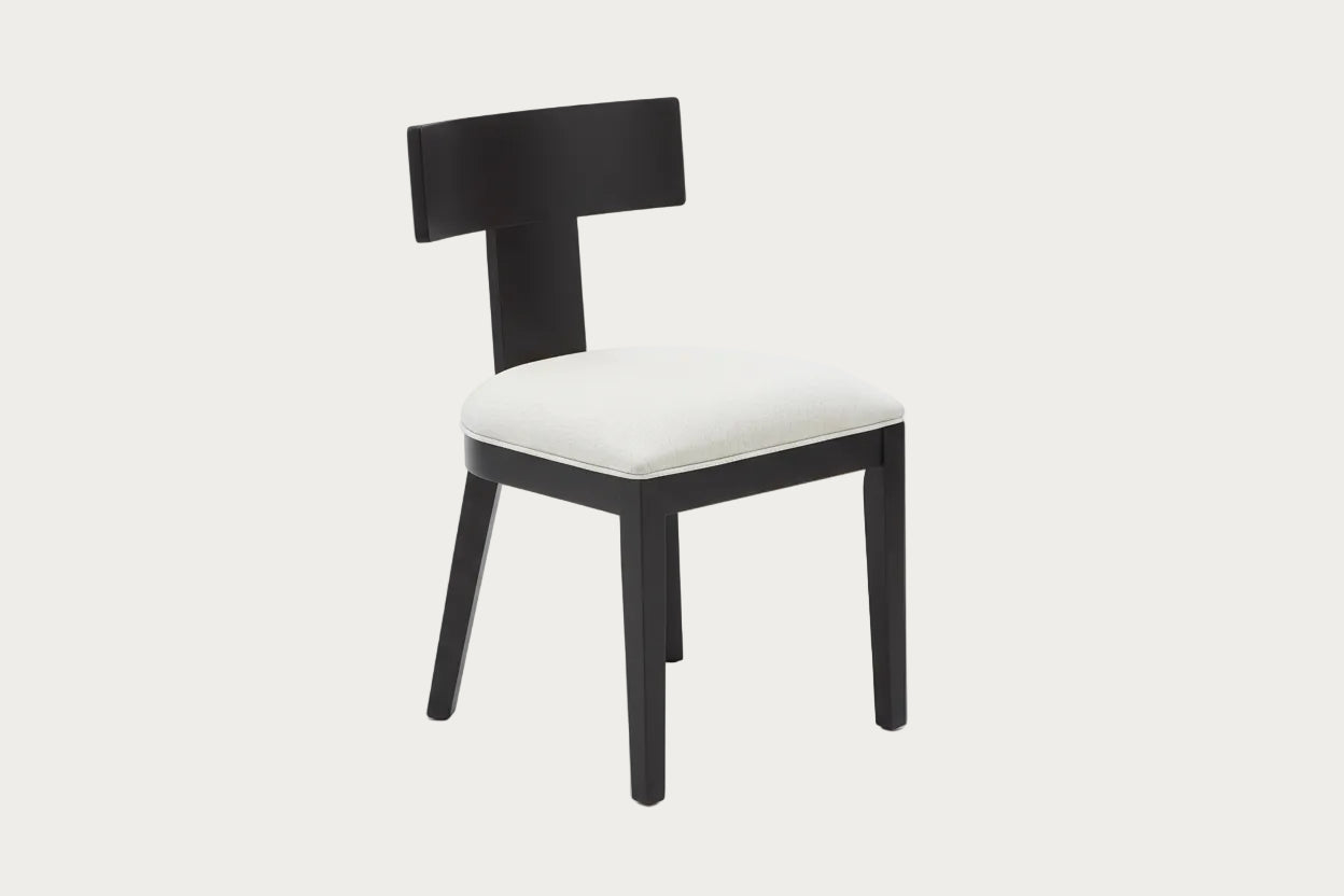 Edith side chairs with black frames and white cushioned seats on a wooden floor.