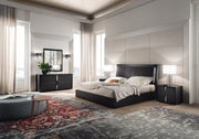 Etna modern bedroom with a bed, nightstands, and decor elements.
