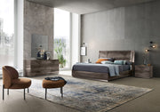 Favignana modern bedroom with wooden furniture, large windows, and decorative elements.