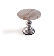 The Focus round marble-top table with metallic base on a white background
