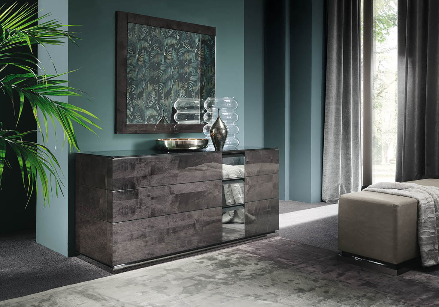 Heritage modern with a dark wood dresser, mirror, and decor items.