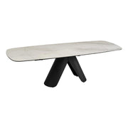 The Tirol extendable dining table with a marble-like top and black legs on a gradient background.
