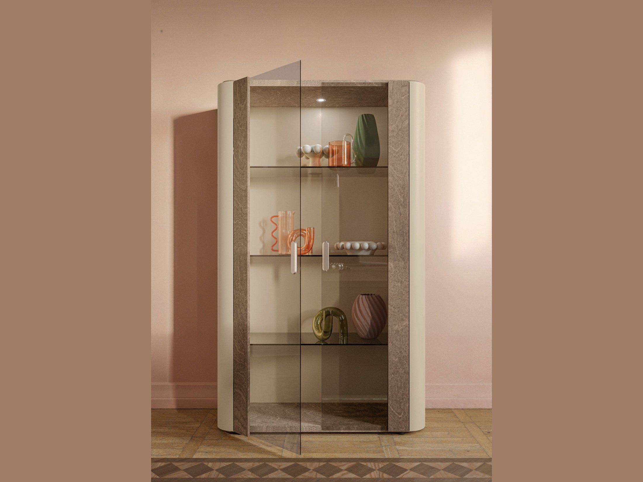 Hebe curio cabinet with glass shelves against a pink wall
