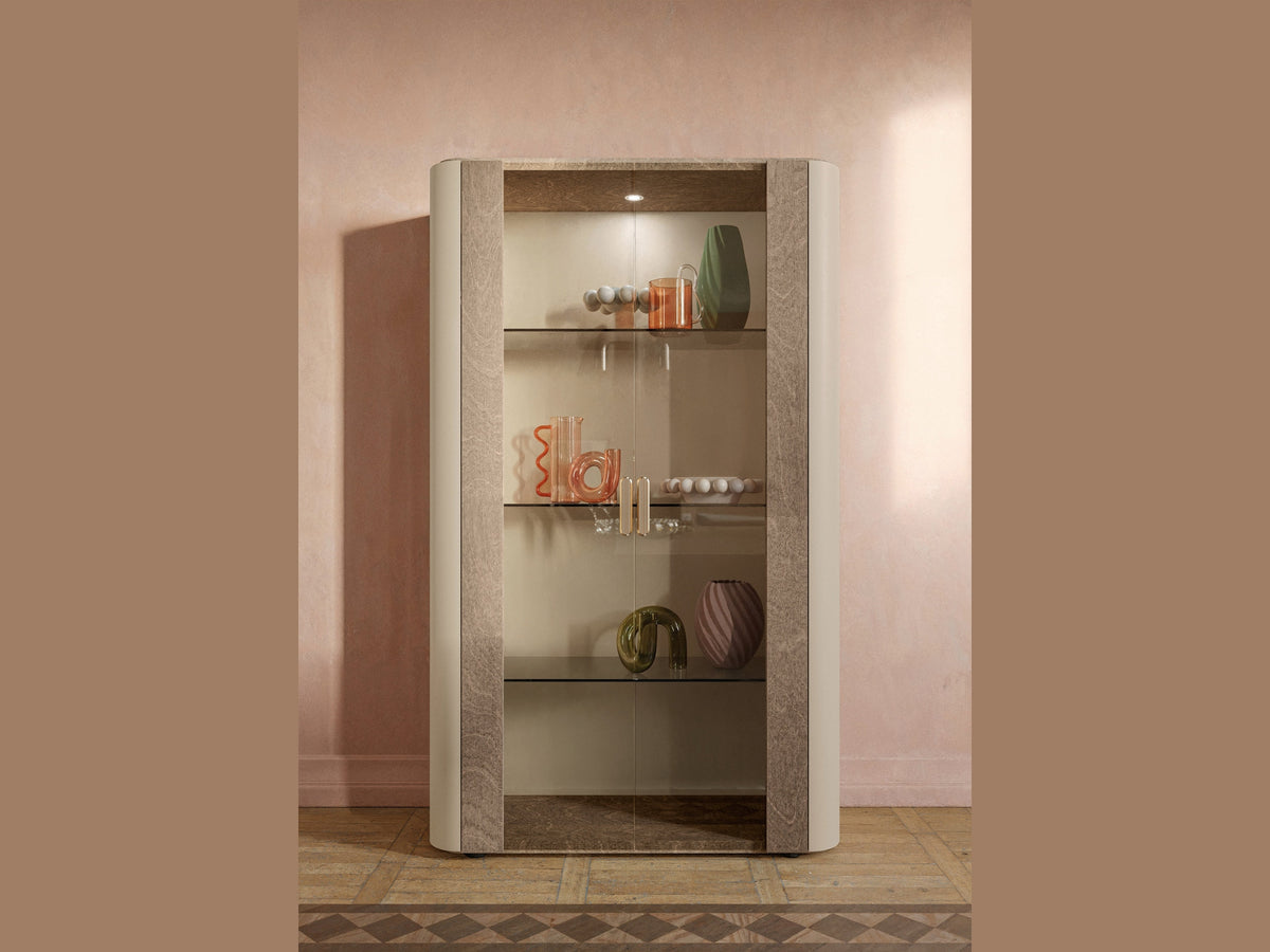 Hebe display cabinet with glass shelves against a pink wall