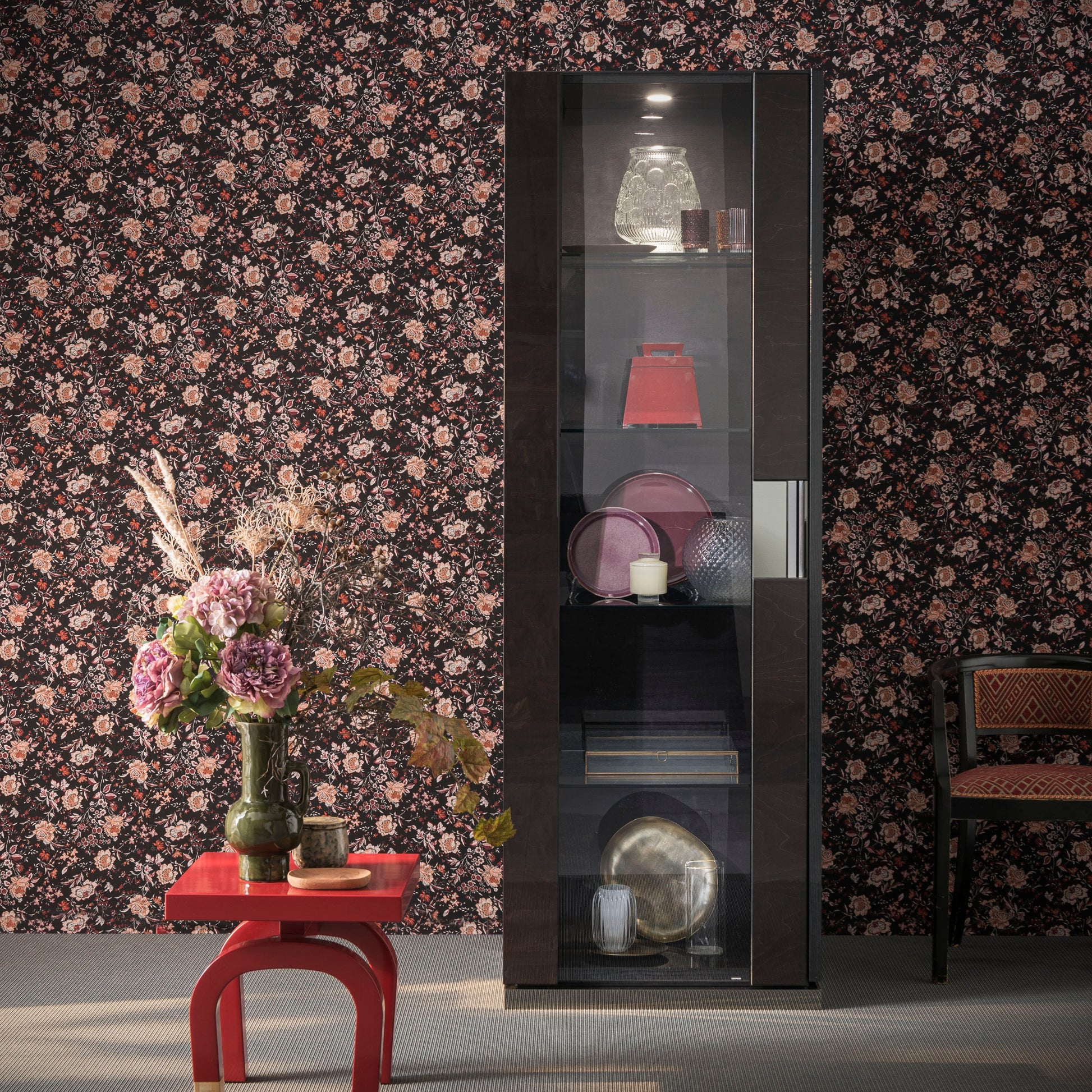 Heritage 1-Door Display cabinet with decorative items against a floral wallpapered wall.