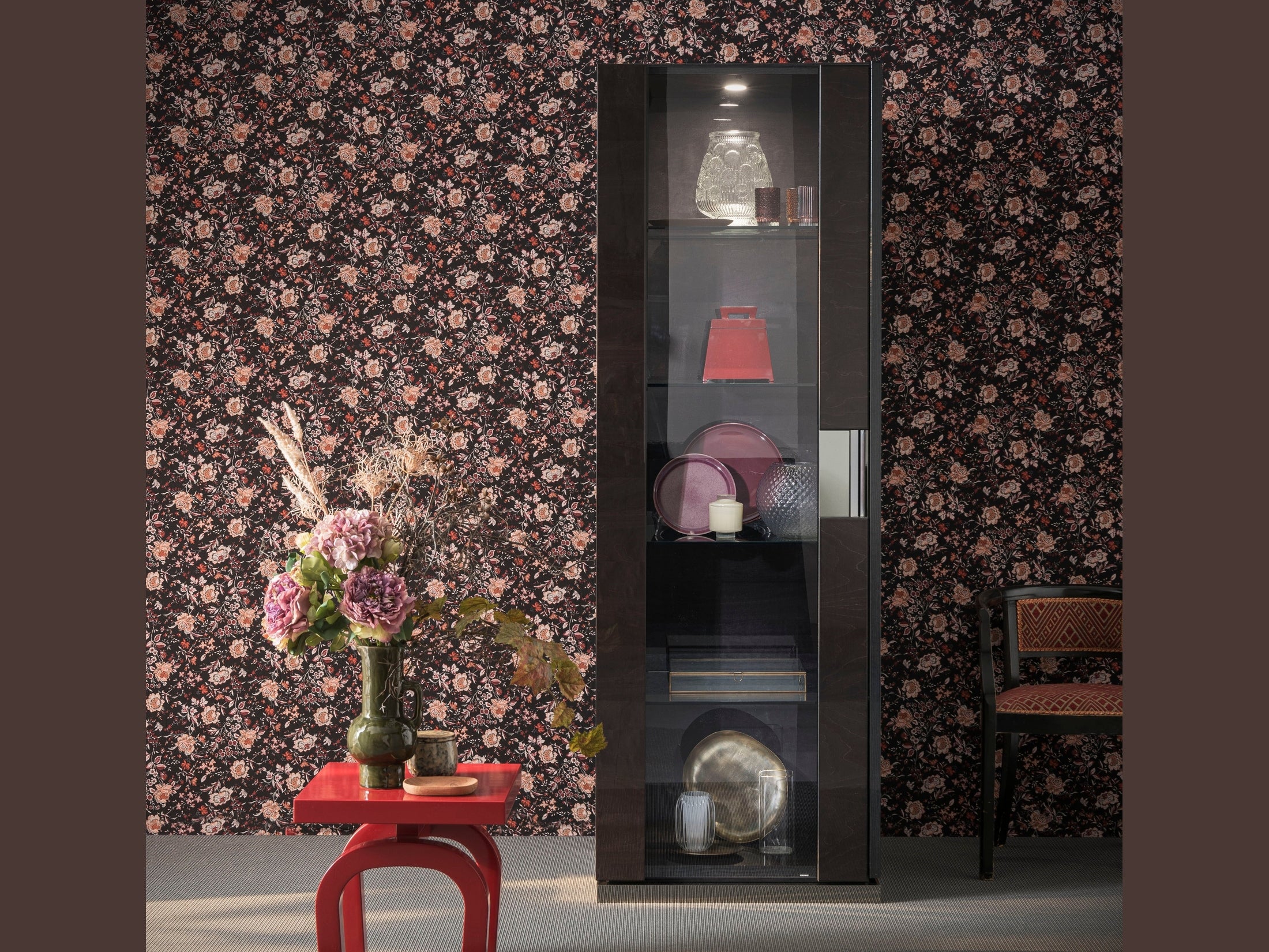 Heritage 1-Door Display cabinet with decorative items against a floral wallpapered wall.