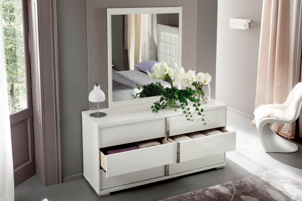 Imperia white dresser with mirror, flowers, and decor in a bedroom setting