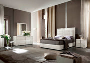 Imperia modern bedroom with gray walls, white furniture, and decorative elements.